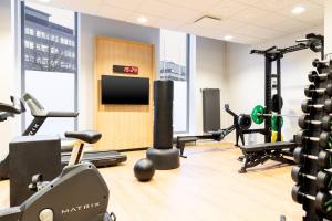 a gym with cardio equipment and a flat screen tv at Courtyard Tampere City in Tampere +28 photos