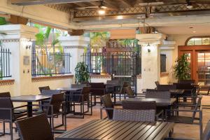 a restaurant with tables and chairs in a building at Courtyard San Diego Old Town in San Diego