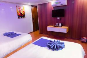 Postel nebo postele na pokoji v ubytování Sapa Grand Blue Hotel