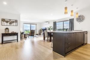 a kitchen and living room with a table and a dining room at Ocean Vista in Lakes Entrance