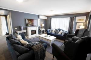 a living room with two couches and a fireplace at Lakehouse on Waverley in Paynesville