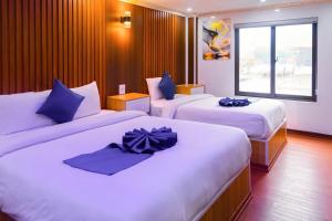 Postel nebo postele na pokoji v ubytování Sapa Grand Blue Hotel