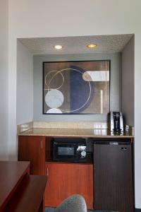 a kitchen with a counter top and a microwave at Courtyard by Marriott San Antonio Airport in San Antonio