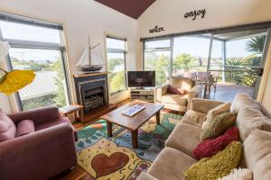 a living room with couches and a fireplace and a tv at Aqua Vista in Paynesville