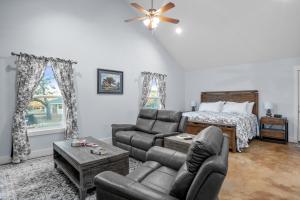 a living room with a couch and a bed at Appian Way Maltese Cottage in Fredericksburg