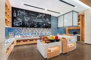 a large kitchen with a chalkboard on the wall at Fairfield by Marriott Beijing Daxing Airport in Beijing
