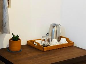 a wooden tray with a coffee maker on a table at Moon Bay in Mirissa