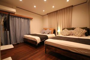 a hotel room with two beds and a window at Nakai House in Tokyo +35 photos