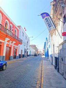 a street with a sign on the side of a building at Samay Misti Apartment in Arequipa