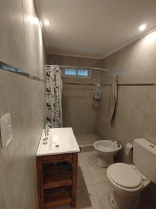 a bathroom with a toilet and a sink at Casa en Chapadmalal con Piscina in Mar del Plata