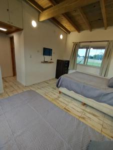 a bedroom with a bed and a television in it at Casa en Chapadmalal con Piscina in Mar del Plata