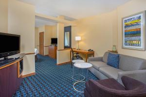 a living room with a couch and a tv at Fairfield Inn & Suites Cookeville in Cookeville