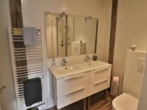 a bathroom with a sink and a shower with a mirror at Charmante maison à Groix, 2 chambres - FR-1-813-14 in Groix