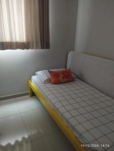 a small bed with a pillow on it in a room at Mi casa su casa 4 in Londrina +25 photos