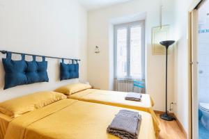 En eller flere senge i et værelse på Casa Elena - ItalyHolidayHouse