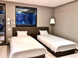 Postel nebo postele na pokoji v ubytování Hotel Square FujiGotemba