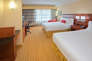 a hotel room with two beds and a desk at Courtyard Louisville Northeast in Louisville +8 photos