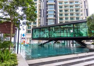 a glass bridge over a river in a city at The Shore l Exclusive Private Garden l Luxury Suite l 4-9 pax l Melaka River View l Direct Mall l Jonker Street by Jay Stay Management in Melaka