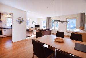 a living room with a dining table and a living room at Am Darßwald Haus 2 1 in Prerow