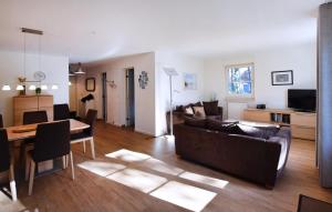a living room with a couch and a table at Am Darßwald Haus 2 1 in Prerow