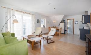a living room with a couch and a table at Waldstr 7 Wo 6 in Prerow