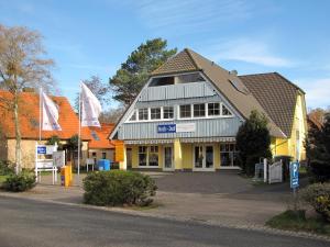 a building with flags on the side of a street at Waldstr 7 Wo 6 in Prerow