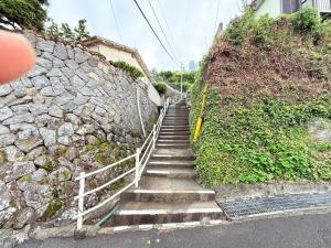 a set of stairs next to a stone wall at 高平ハウス Room203 in Nagasaki +10 photos