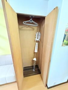 ajar door of a room with a phone in it at 高平ハウス Room203 in Nagasaki