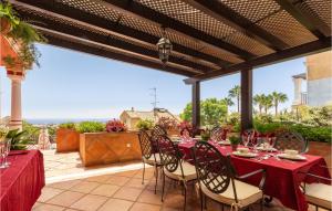 a patio with a table and chairs on a patio at 6 Bedroom Awesome Home In Marbella in Marbella +70 photos