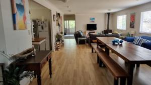 a living room with wooden tables and a couch at There's Room For All in Hawks Nest