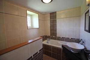 a bathroom with a sink and a bath tub at La feuillardiere in Dournazac +34 photos