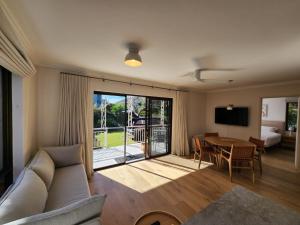 a living room with a couch and a table at Amazing 3bd in National Park in Bundeena