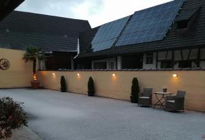 a house with solar panels on the side of it at Dreiländereck-Ferienwohnung in Eschbach in Eschbach