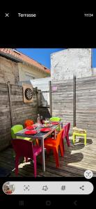 a table and chairs on a wooden deck at Grain de sable ! terrasse en ville in Le Touquet-Paris-Plage