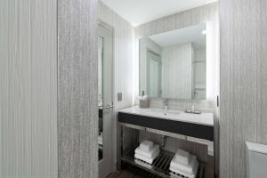 a bathroom with a sink and a mirror at Fairfield by Marriott Inn & Suites Boston Medford in Medford +29 photos