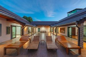 a row of wooden benches in a building at V155 4BR Large Family Villa Chalong in Chalong 