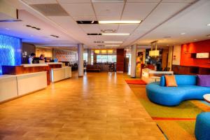 an office lobby with blue couches and a bar at Fairfield Inn & Suites by Marriott Princeton in Princeton +20 photos