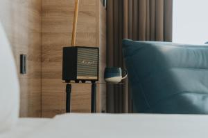 a tv sitting on a stand next to a pillow at 緩慢大鵬灣 in Donggang