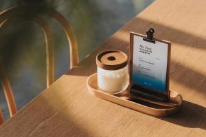 a tablet sitting on a table with a cup of coffee at 緩慢大鵬灣 in Donggang