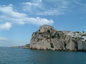 a rocky island in the water with houses on it at Casa da Tonia Peschici in Peschici