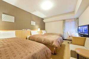 Tempat tidur dalam kamar di Hotel Sunroute Sapporo