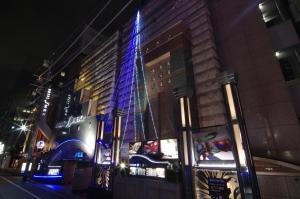 a building with a blue christmas tree on it at HOTEL & SPA J-MEX Shinjuku Kabukicho (Adult Only) in Tokyo