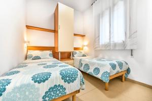 a bedroom with two beds and a window at Jesolo Sun Beach House - Host Solution in Lido di Jesolo