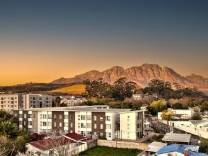 een stad met gebouwen en bergen op de achtergrond bij WINK Aparthotel Quiver Tree in Stellenbosch