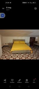 a bedroom with a bed with a yellow blanket at Esperia in Caorle