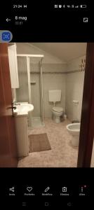 a bathroom with a toilet and a sink at Esperia in Caorle +6 photos