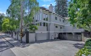 an image of a white house with a driveway at 495 - Upscale Home with AC and Patio near Meta and Stanford in Menlo Park