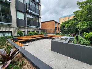 a patio with benches and a table in a building at Discover Kingsford in Sydney