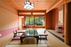 a living room with a table and chairs at Kanouya in Omachi +134 photos