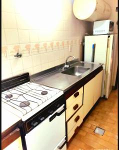 a kitchen with a stove and a sink and a refrigerator at San Bernardo in San Bernardo